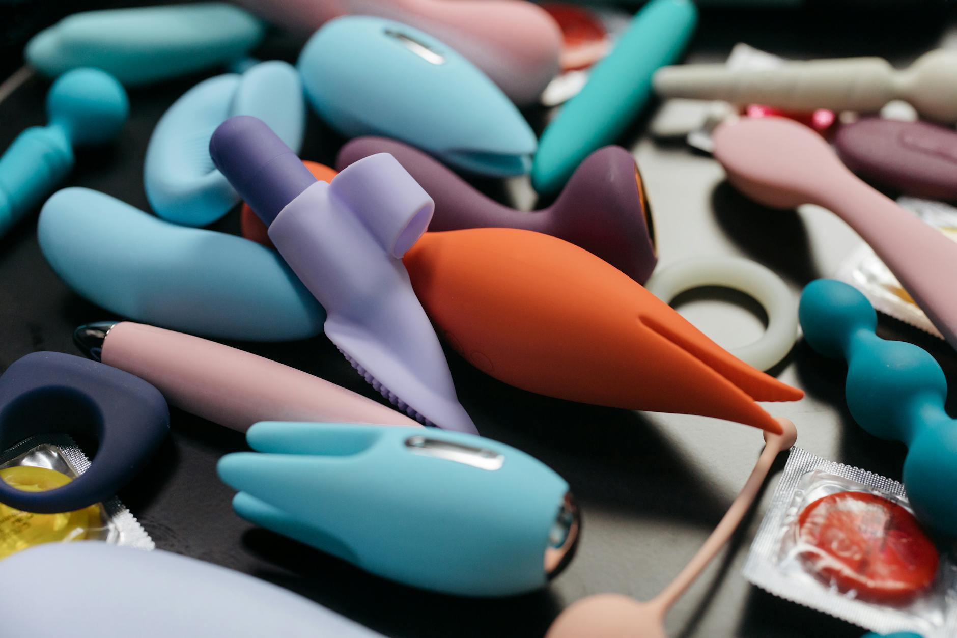 Array of vibrant adult toys including lemon clitoral vibrators and other designs displayed close-up